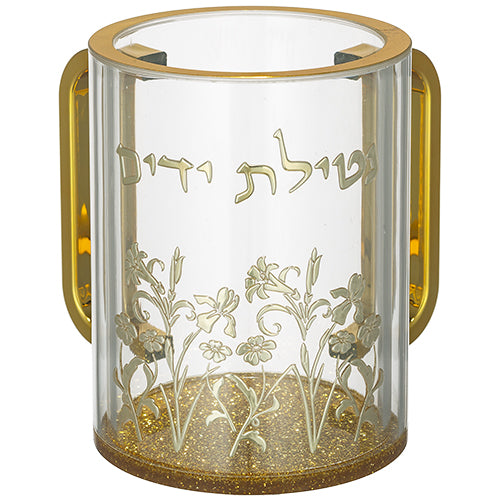 נטלה מהודרת מאקריליק שקוף בגובה 13 ס"מ, עם שתי ידיות מוזהבות, בסיס מוזהב ומנצנץ, וכיתוב בולט בזהב של המילים "נטילת ידיים". החלק התחתון של הנטלה מעוטר באיורי פרחים וענפים בזהב.